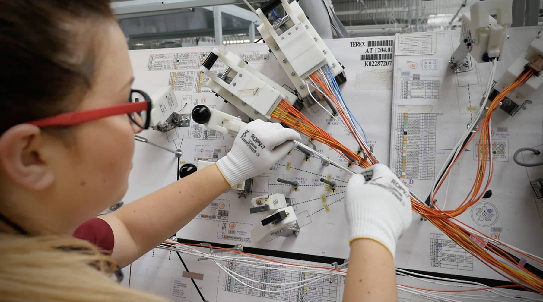 A worker adjusting low voltage cables